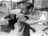 A South Vietnamese Father Carries His Son and a Bag of Household Possessions Photographic Print