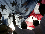 Immigration Rights Demonstrators Hold a U.S. Flag Aloft During a March Along Wilshire Boulevard Photographie