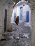 Traditionally Dressed Woman along Cobblestone Alley, Morocco Photographic Print by John & Lisa Merrill