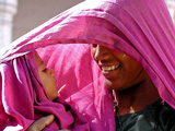 A Woman Shields Her Child from the Sun Using Her Scarf Photographic Print