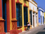 Woman Walking Past Colourful House Facades on Street, Campeche, Mexico Photographic Print by John Elk III
