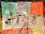 A Soccer Ball Slips Through an Opening of a Makeshift Goal During a Game Played by Bosnian Children Photographic Print