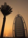Palm Tree Next to Burj Al Arab Hotel at Sunset, Dubai, United Arab Emirates Photographic Print by Holger Leue