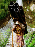A Women Carrying a Heavy Load Across a Bridge, Kalopani, Annapurna Circuit, Nepal Photographic Print by Andrew Parkinson