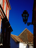 Building Facade, Roof and Street Lamp in Alfama District, Lisbon, Portugal Photographic Print by Izzet Keribar