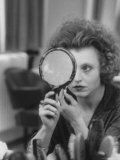 Actress Hanna Schygulla Looking in Hand Mirror While Applying Makeup Premium Photographic Print by Alfred Eisenstaedt