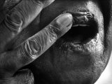Jazz Trumpeter Louis Armstrong Massaging Lips with Balm to Keep Them Strong for Playing His Trumpet Premium Photographic Print by John Loengard