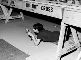 Female Fan Peering Underneath Police Barrier Hoping to Get a Look at Members of the Rolling Stones Premium Photographic Print by Walter Daran