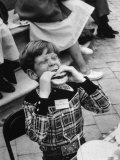 Hollywood Child Timmy Garry at Children's party Dressed in Cowboy Outfit eating a Hamburger Photographic Print by J. R. Eyerman