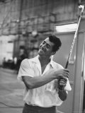 Singer and Actor Dean Martin holding a pitching club on Movie Set for MGM's "Some Came Running" Premium-Fotodruck von Allan Grant