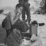 GI shaving with mirror during ull in the Ardennes Forest Conflict called the Battle of the Bulge Photographic Print by John Florea
