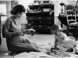 Jackie Kennedy, Wife of Sen, Cutting Out Newspaper Clippings Next to Open Scrapbook Premium Photographic Print by Alfred Eisenstaedt
