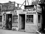 Shack Like Black Jeweler Shop Next to Food Store Covered with Ads in a Slum Section of the City. Premium Photographic Print by Alfred Eisenstaedt