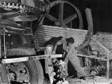 African American Worker Mrs. Rosalie Ivy Using Shovel to Mix a Special Mud Used to Seal the Hole Premium Photographic Print by Margaret Bourke-White