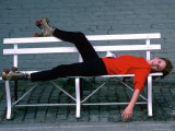 Actress Melissa Gilbert Reclining on a Bench While Wearing Roller Skates Premium Photographic Print by David Mcgough