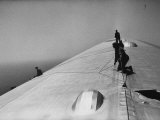 Maintenance Crewmen on Top of Graf Zeppelin repair damage caused Atlantic Ocean Storm during flight Premium Photographic Print by Alfred Eisenstaedt