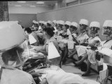 Women under Hair Dryers Getting Hair Styled in Beauty Salon at Saks Fifth Ave. Department Store Photographic Print by Alfred Eisenstaedt