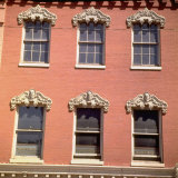 Brick Facade of 19th Century Building with Ornate Stonework Around Windows Photographic Print by Walker Evans