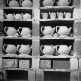 Cheap Chinaware Saucers, Cups, Teapots, Etc Standing on Racks in Pottery of the Hall China Co Photographic Print by Walker Evans
