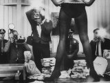 Actress Angie Dickinson's Lower Half Straddling a Million Dollars in Fake Money Premium Photographic Print by John Dominis