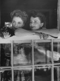 Actress Joan Fontaine with Actress Sister Olivia de Havilland Looking Out of Open Window at Home Premium Photographic Print by Bob Landry