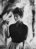 Actress Sophia Loren Examining a Tiny Flower Outside Premium Photographic Print by Alfred Eisenstaedt