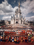 Walt Disney Characters and Park Staff Posing En Masse in Front of Cinderella's Castle Photographic Print by Yale Joel