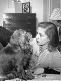 Actress Lauren Bacall Chatting with Her Cocker Spaniel Dog in Her Suite at Gotham Hotel Premium Photographic Print by Nina Leen