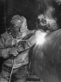 Worker Welding Pipe Used in Natural Gas Pipeline at World's Biggest Coal Fueled Generating Plant Photographic Print by Margaret Bourke-White