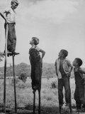 Kenneth Merriman on higher stilts than his brothers and friend Premium Photographic Print by Robert W. Kelley