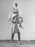 Sikh Carrying His Wife on Shoulders in Convoy Migrating to East Punjab After the Division of India Lámina fotográfica por Margaret Bourke-White