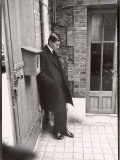 Christian Dior's Successor Yves Saint Laurent Standing Alone After Attending Dior's Funeral Reproduction photographique sur papier de qualité par Loomis Dean