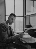 Harvard University Professor John Kenneth Galbraith Sitting in a Harvard Library Premium Photographic Print by Dmitri Kessel