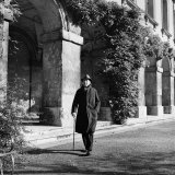 Scholar C.S. Lewis Walking with Cane Near Building at Magdalen College, Oxford University Premium Photographic Print by Hans Wild