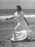 Claudette Colbert in Zippered, Terry Cloth Beach Robe, Sashaying Along Surf at Santa Monica Beach Premium Photographic Print by Peter Stackpole