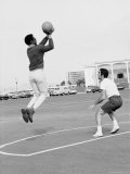 Comedian Bill Cosby Shooting Ball Against His Press Agent, Joe Sutton, During Game of Basketball Premium Photographic Print by Michael Rougier