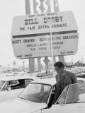 Comedian Bill Cosby Getting Into Car in Front of Sands Hotel Marquee with His Name on It Reproduction photographique sur papier de qualité par Michael Rougier