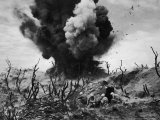 US Marines Crouching Behind Hillside Rock Cover, Blowing Up Cave Connected to Japanese Blockhouse Photographie par W. Eugene Smith