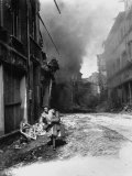 German Woman Carrying Possessions While Running from Building on Fire Started by Nazi Saboteur Premium Photographic Print by Troy A. Peters