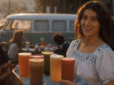 Waitress Carrying Tray of Carrot, Celery. Beet, Orange, Apple, and Grapefruit Juice at "The Source" Premium-Fotodruck von Michael Rougier