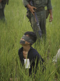 Viet Cong Prisoner Being Guarded by Marines, Mouth and Eyes Taped to Prevent From Calling for Help Photographic Print by Paul Schutzer