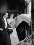 Count and Countess Jean Yves de La Cour Saying Hello to Horse Reproduction photographique sur papier de qualité par Gordon Parks