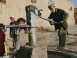 An Elderly Man Pumps Water from a Public Well in Kabul, Afghanistan, Friday, September 22, 2006 Photographic Print by Rodrigo Abd