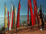 A Bhutanese Man Straightens a Prayer Flag at a Buddhist Shrine Photographic Print