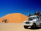 Men on Four Wheel Drive Vehicle at Dune 45 in Namib Nauklaft National Park, Sossusvlei, Namibia Photographic Print by Christer Fredriksson