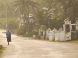 Woman Walking in Sea Mist, Bathsheba, Barbados Photographic Print by Walter Bibikow