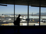 A Silhouette Walks Past a Window Looking Out at the Tarmac, Vancouver, British Columbia, Canada Photographic Print by Taylor S. Kennedy