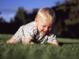 A Baby Boy Crawls Through the Green Grass Photographie par Joel Sartore
