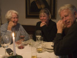 A Family Sits Around the Dinner Table at a Restaurant, Fraueninsel, Chiemsee, Bavaria, Germany Photographic Print by Taylor S. Kennedy