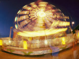 A Slow Exposure Captures Lights on a Spinning Carnival Ride Photographic Print by Heather Perry